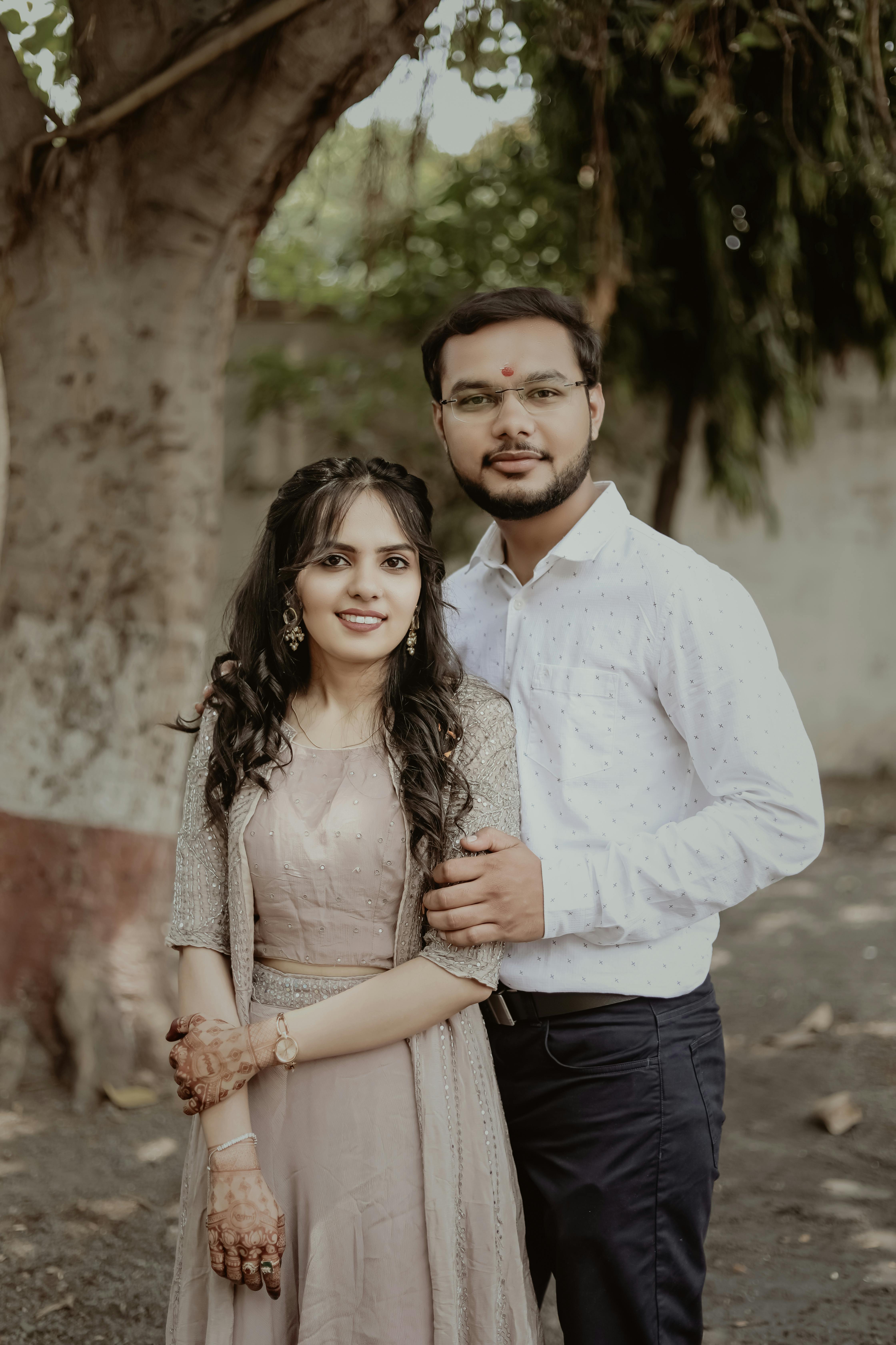 Free Photos - A Happy Moment Of A Young Couple Standing Next To Each Other,  Smiling And Posing For A Photo. The Background Is Filled With Several Other  People, Indicating That The